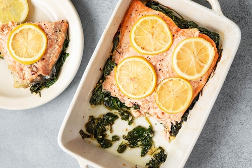 Baked salmon over spinach